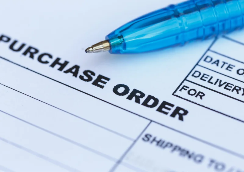 Purchase order and blue pen